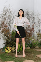 High-waisted pleated silk skirt with elegant flow and tailored waistband for refined styling